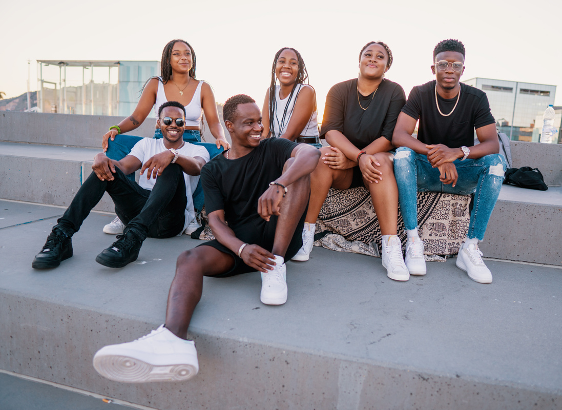 Group of young modern african black friends happily sitting together